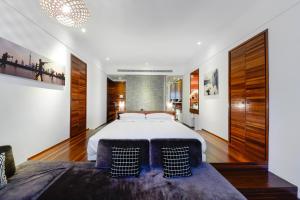 a bedroom with a large bed and wooden floors at URBN Boutique Shanghai in Shanghai