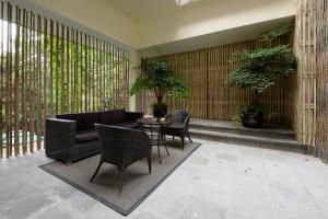 a patio with a couch and chairs and a table at URBN Boutique Shanghai in Shanghai