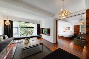 a living room with a couch and a bed at URBN Boutique Shanghai in Shanghai