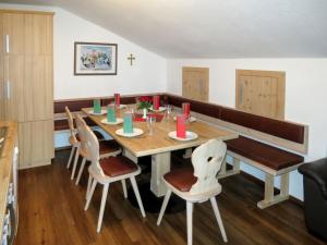 a dining room with a wooden table and chairs at Apartment Klammlhof - ZAZ307 by Interhome in Zell am Ziller