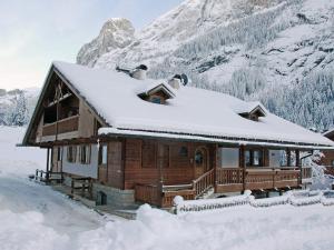 a log cabin with snow on the roof at Chalet Cesa Galadriel-1 by Interhome in Penia