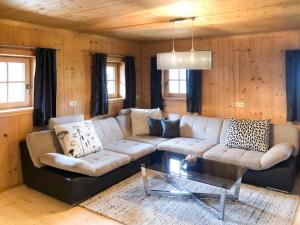 a living room with a couch and a table at Chalet Alm Chalet by Interhome in Gattererberg