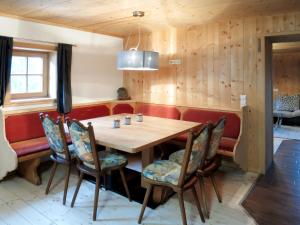 a dining room with a wooden table and chairs at Chalet Alm Chalet by Interhome in Gattererberg