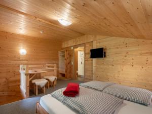 A bed or beds in a room at Chalet Talbach by Interhome