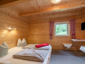 A bed or beds in a room at Chalet Talbach by Interhome