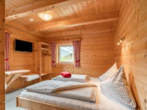 A bed or beds in a room at Chalet Talbach by Interhome