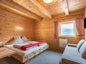 A bed or beds in a room at Chalet Talbach by Interhome