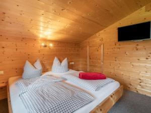 A bed or beds in a room at Chalet Talbach by Interhome