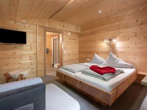 A bed or beds in a room at Chalet Talbach by Interhome