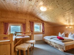 A bed or beds in a room at Chalet Talbach by Interhome