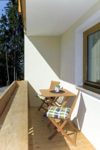 a patio with a table and chairs on a balcony at Apartment Lisi - SUZ372 by Interhome in Stummerberg
