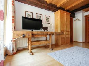 a television on a wooden table in a living room at Apartment Beim Holzschnitzer-1 by Interhome in Sölden +26 photos