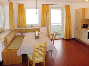 a kitchen and dining room with a table and chairs at Apartment Haus Huber - ZAZ403 by Interhome in Zell am Ziller