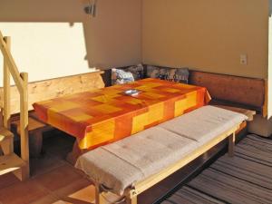 a wooden table in a room with a wooden bench sidx sidx sidx at Holiday Home Reichegger by Interhome in Grün