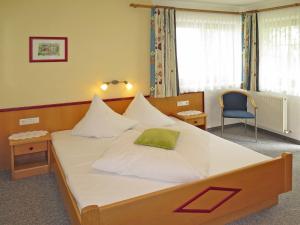 アシャウにあるApartment Haus Sonne - ZAZ681 by Interhomeのベッドルーム1室(緑の枕が付いたベッド1台付)