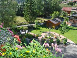 an aerial view of a garden with flowers and a cabin at Apartment Stark-1 by Interhome in Pettneu am Arlberg