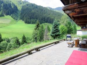 a porch of a cabin with a view of the mountains at Holiday Home Berghaus - MHO764 by Interhome in Hippach