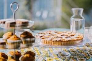 a table with a pie and other pastries on it at Villa Eris Amalfi Coast in Conca dei Marini