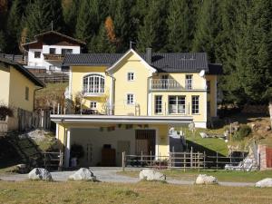 a large yellow house on a hill at Villa Marie-Sophie by Interhome in Mallnitz