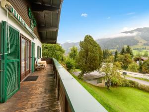 a balcony of a house with a view of the mountains at Holiday Home Riki by Interhome in Bruck an der Großglocknerstraße