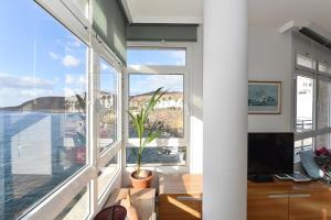 A television and/or entertainment centre at Apartment El Confital RF18 by VillaGranCanaria