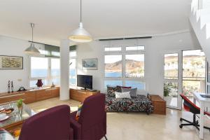 A seating area at Apartment El Confital RF18 by VillaGranCanaria