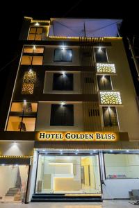 a hotel golden bites is lit up at night at Hotel Golden Bliss in Bhopal