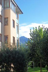 a tall building with a view of a mountain at Apartment Haus Kitzsteinhorn by Interhome in Zell am See