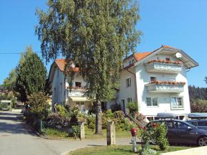 a large white building with a tree in front of it at Apartment Frank-2 by Interhome in Feldkirchen in Kärnten