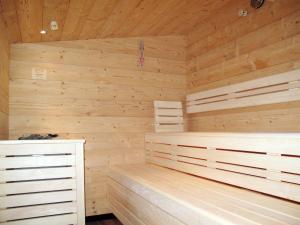 a sauna with wooden walls and wooden floors at Apartment Alpenherz - PTZ430 by Interhome in Fendels