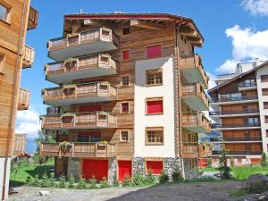 a building with balconies on the side of it at Apartment Les Etagnes 2est by Interhome in Nendaz