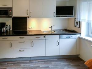 a kitchen with white cabinets and a sink at Apartment Leni - FIE151 by Interhome in Fliess