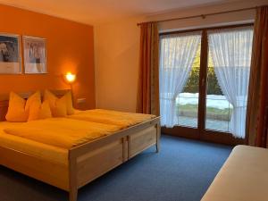 a bedroom with a bed and a large window at Apartment Christina by Interhome in Tarrenz +22 photos