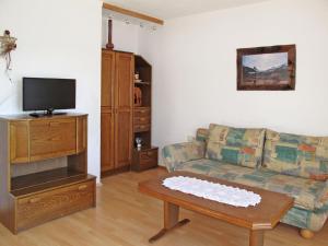 a living room with a couch and a coffee table at Apartment Steinwender by Interhome in Nauders