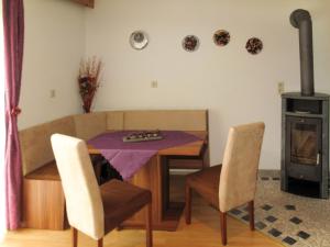 a dining room with a table and chairs and a stove at Apartment Steinwender by Interhome in Nauders +13 photos