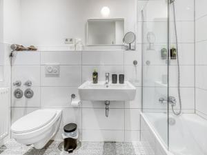 a bathroom with a toilet and a sink and a shower at limehome Essen Kibbelstraße in Essen