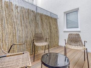 two chairs and a table on a balcony at limehome Essen Kibbelstraße in Essen