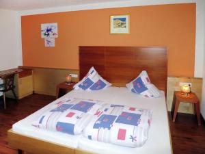 a bedroom with a large bed with a wooden headboard at Apartment Apart Sonja by Interhome in Kappl +20 photos