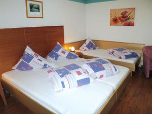 two beds in a room with blue and white pillows at Apartment Apart Sonja by Interhome in Kappl