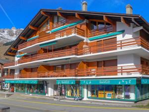 a large building with balconies on the side of a street at Apartment Atlantic 112 by Interhome in Verbier