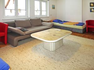 a living room with a couch and a coffee table at Apartment Dobler - LNR110 by Interhome in Lorüns