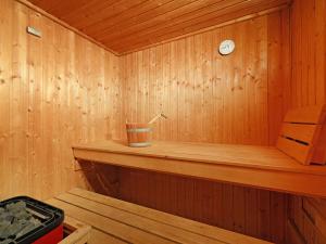 a wooden sauna with a clock on the wall at Apartment Bodmen A by Interhome in Zermatt