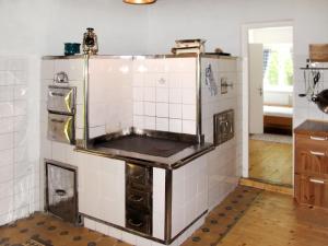 a kitchen with a stove top oven in a room at Chalet Waldweber - SWG100 by Interhome in Kruckenberg
