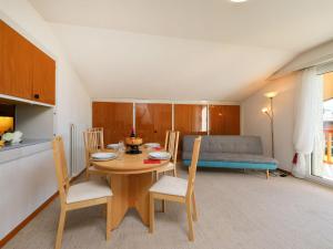ヴィラール・シュル・オロンにあるApartment Residence du Golf B18 by Interhomeのキッチン、ダイニングルーム(テーブル、椅子付)