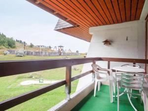 a balcony with a table and chairs and a view of a field at Studio Résidence Arzinol by Interhome in Les Collons