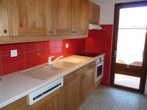 オヴロナにあるApartment Grand Garde No 6 by Interhomeの赤いタイルのキッチン(シンク付)