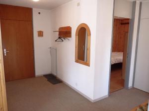a room with a door and a mirror on the wall at Apartment Grande-Garde 6 by Interhome in Ovronnaz