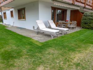 eine Terrasse mit 2 Stühlen und einem Tisch im Hof in der Unterkunft Apartment La Joie by Interhome in Crans-Montana