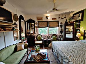 a living room with a couch and a table at On The House in New Delhi