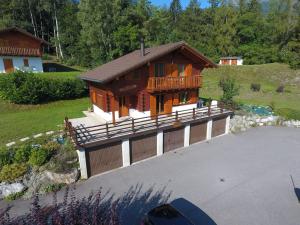 a small house with a balcony and a garage at Chalet L'Escapade by Interhome in Ovronnaz
